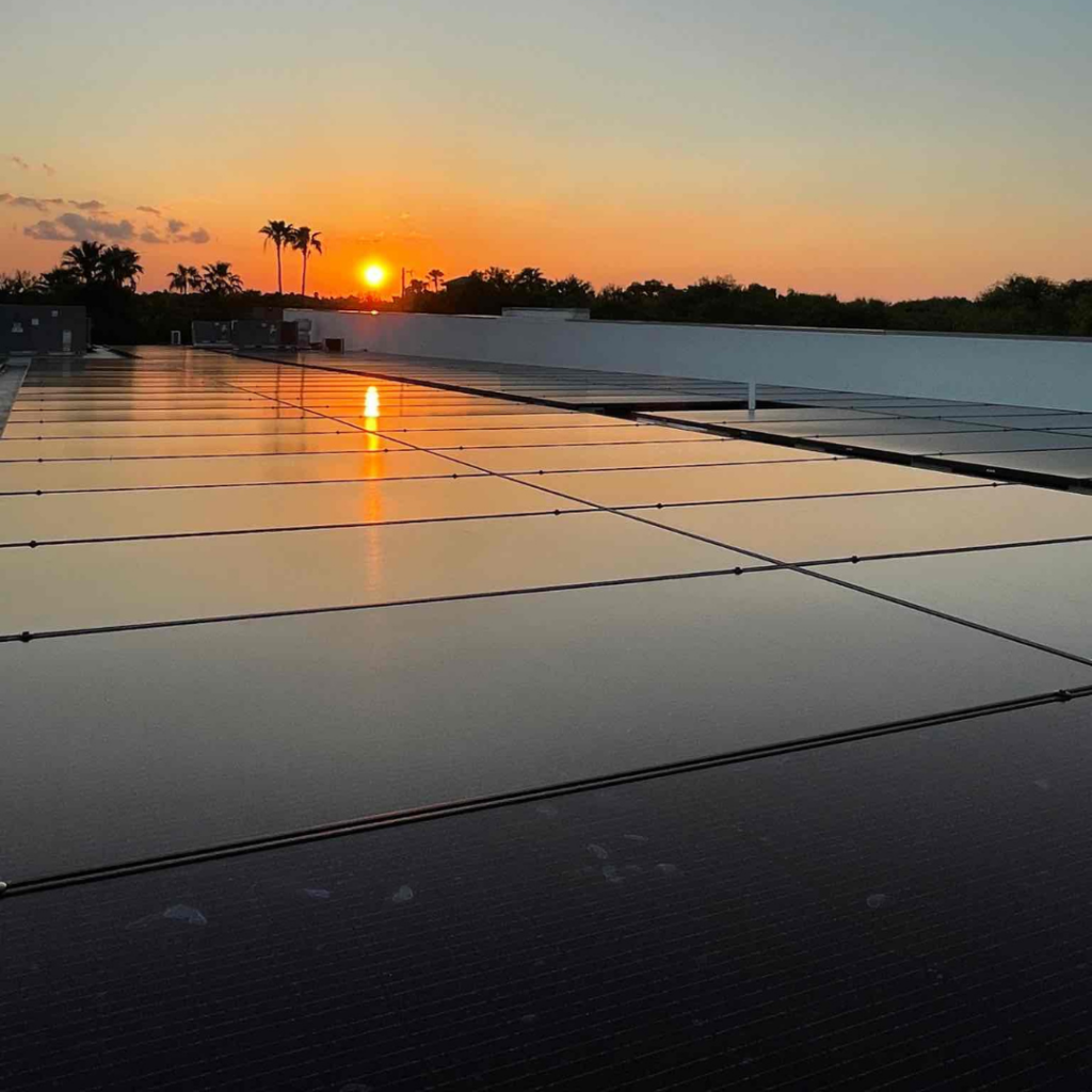 Solar panels installed on the roof of a medical center. The building, used for medical services including MRIs, features a clean, modern design with solar energy infrastructure helping to power the facility. The solar installation is part of a sustainable energy solution for the healthcare facility.