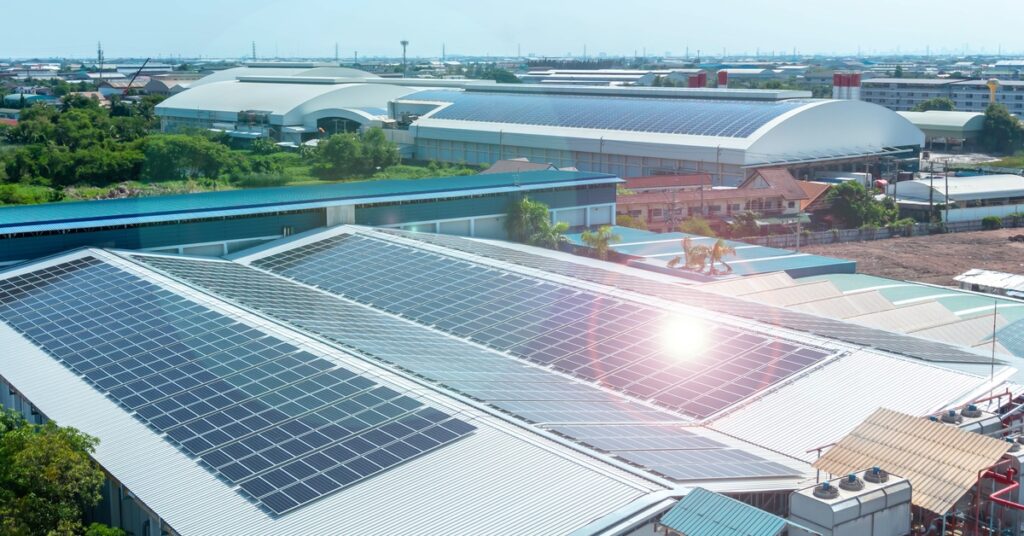 A Guide to Solar Power and LEED Certification 1 Multiple buildings with rows of solar panels covering the roofs, with trees and other buildings in the background.