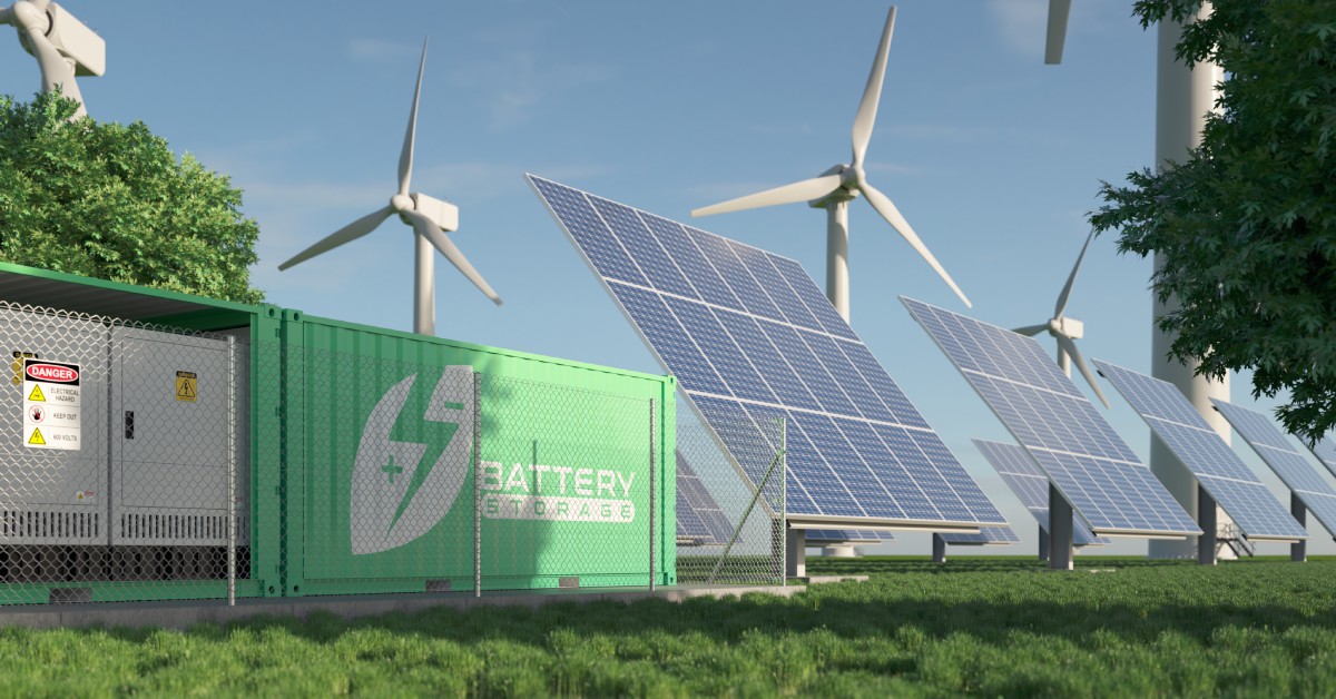 A large battery displaying the words “battery storage” outdoors next to multiple wind turbines and solar panels.