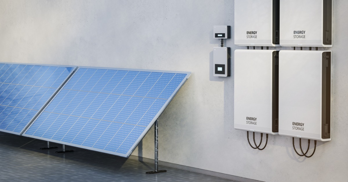 Learn 2 Four white rectangular boxes placed on a wall next to each other, with two large solar panels on the side.