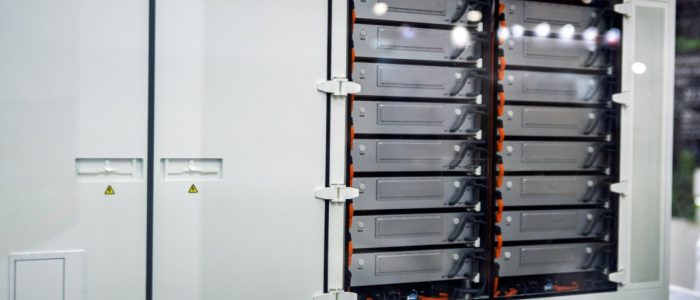 A close-up of a large box outdoors with multiple smaller interior boxes and cables attached on the right side.