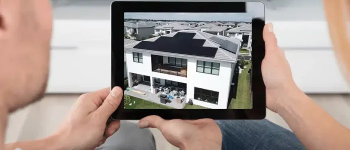 two people looking at solar panels on a tablet